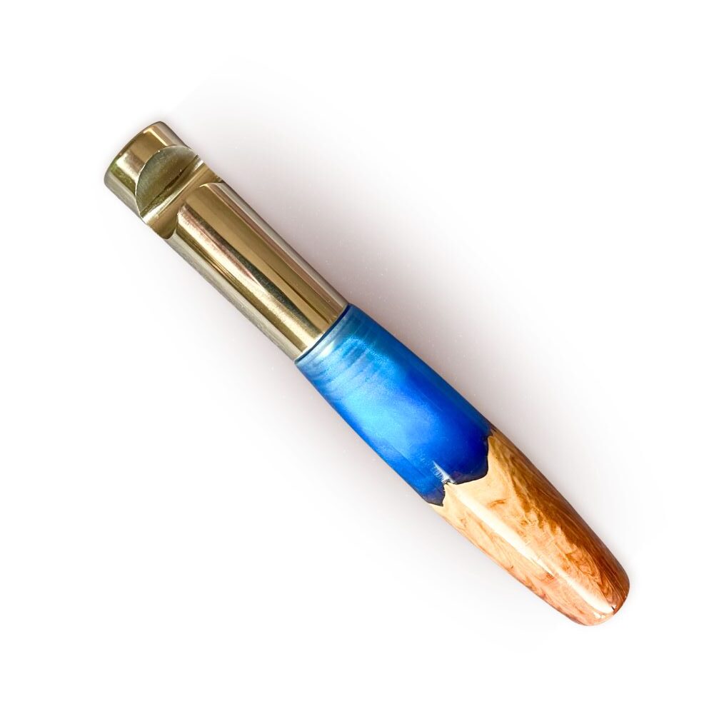 Close-up of handcrafted olive wood and blue resin bottle opener handle