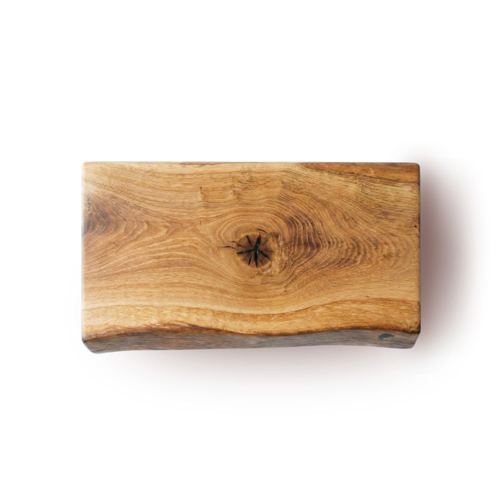 Solid wood live edge chopping board on a white background